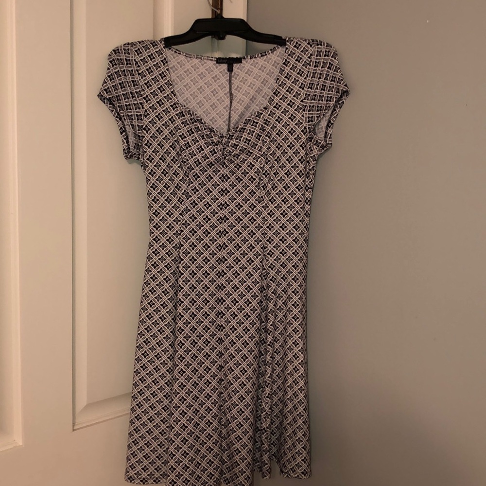 White dress with black design on it